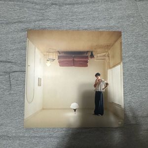 An unopened orange harry’s house vinyl